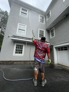 Professional house washing and power washing service cleaning a residential home exterior