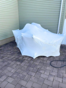 Outdoor furniture professionally shrink wrapped by AnA Home Services, providing weather-resistant protection for long-term storage.