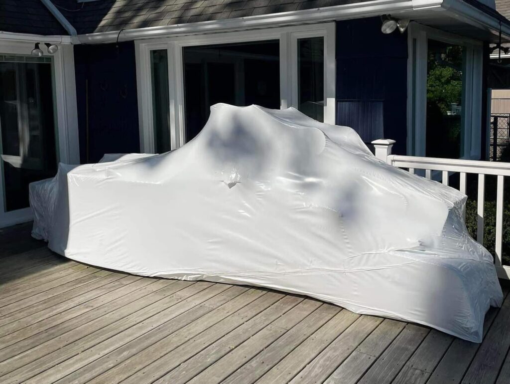 Outdoor furniture professionally shrink wrapped by AnA Home Services, providing weather-resistant protection for long-term storage.